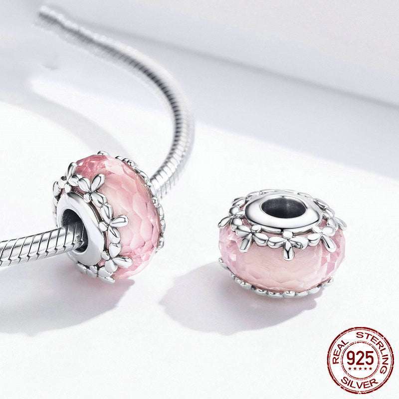 Pink Floral Bead - Delicate Feminine Charm shown on a bracelet, highlighting its floral silver design and pink crystal for stylish accessorizing.