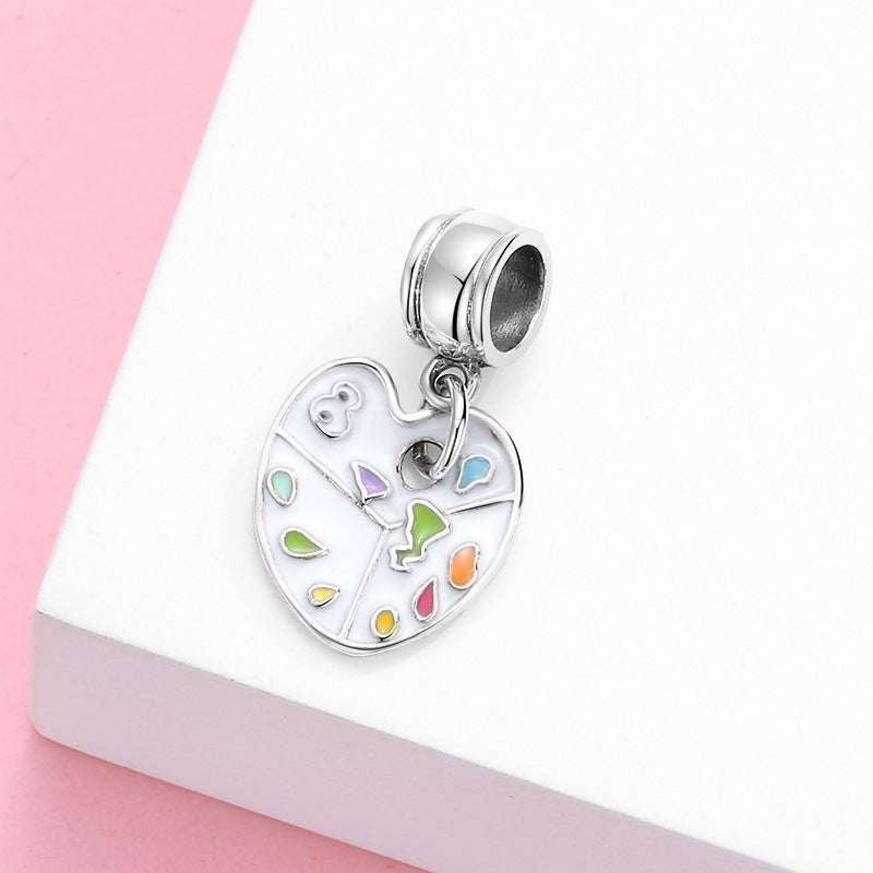 Close-up of Art Palette Charm with multicolored enamel on a white background, ideal for artistic charm bracelets.