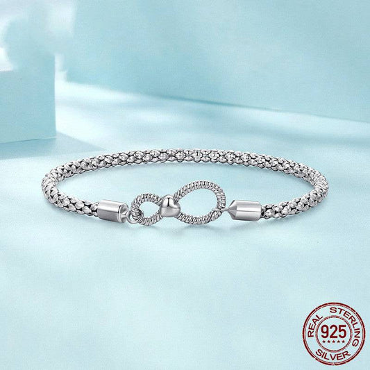 Infinity Knot Silver Bracelet - Elegant Symbol of Forever ♾️✨ displayed on a soft blue background with 925 sterling silver authenticity seal.
