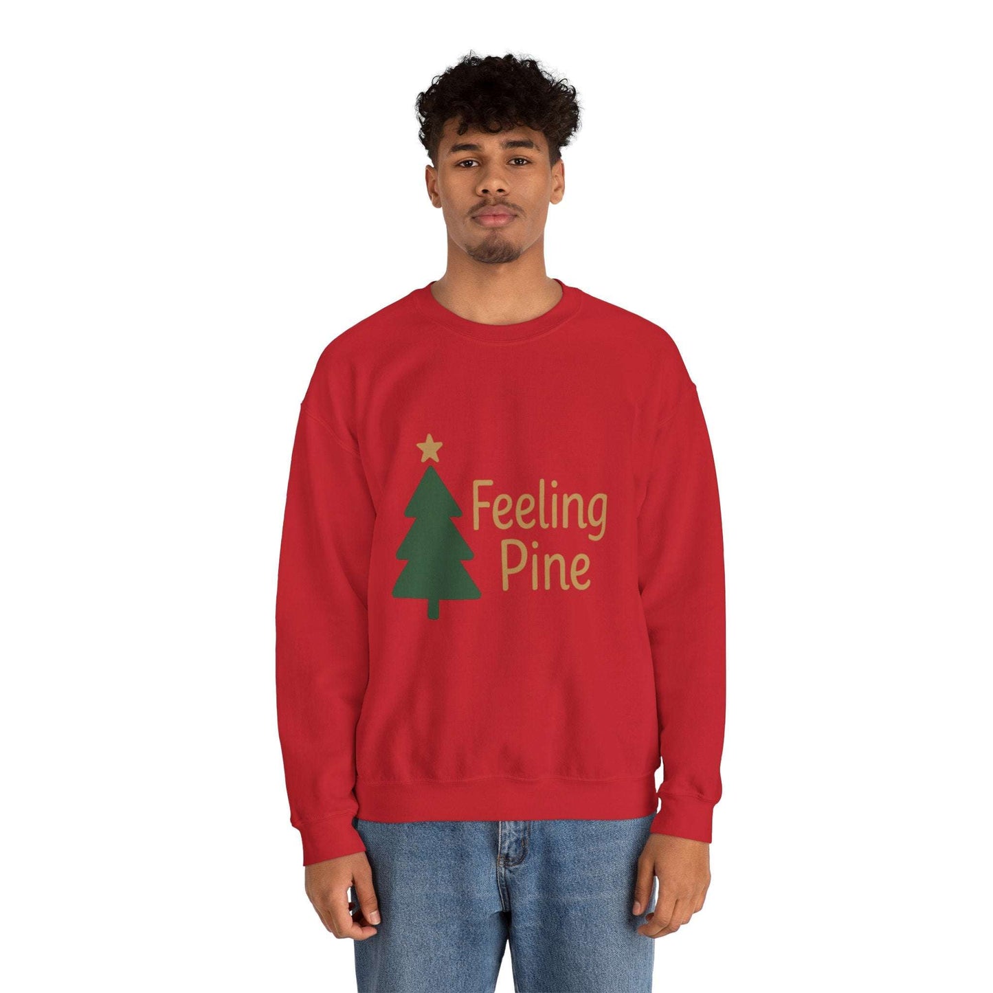 Unisex Feeling Pine Sweatshirt in red with green Christmas tree and gold text, ideal festive apparel for cozy winter gatherings and holiday style.