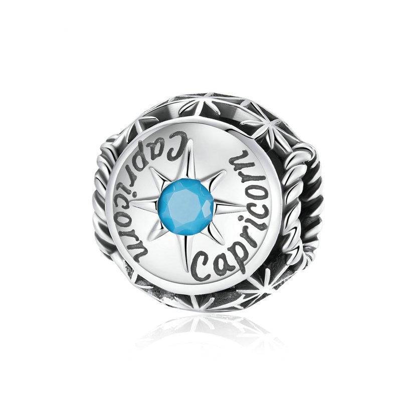 Capricorn Horoscope Charm with turquoise zircon and celestial engraving. Unique zodiac accessory from Zodiac Zircon Jewelry line.
