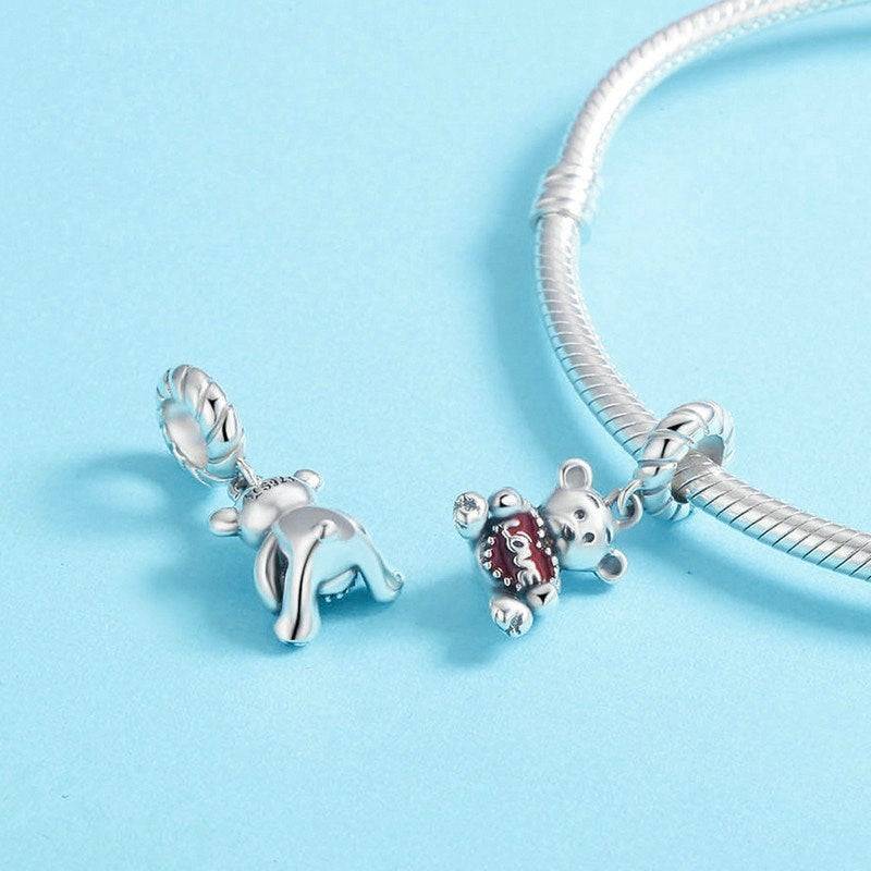 Front and back view of the Love Bear Charm, highlighting detailed silver craftsmanship and red heart design. Great for charm bracelet customization.