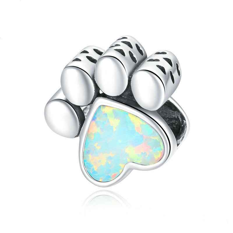 Adorable cute dog paw charm for bracelets featuring a heart-shaped opal center, ideal for pet lovers and charm collectors.