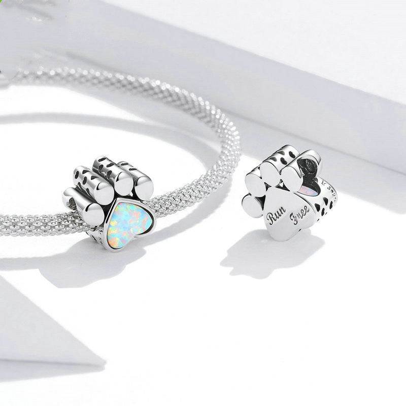 Pair of dog paw charms with opal hearts and engraved back, designed for pet lovers' charm bracelets.