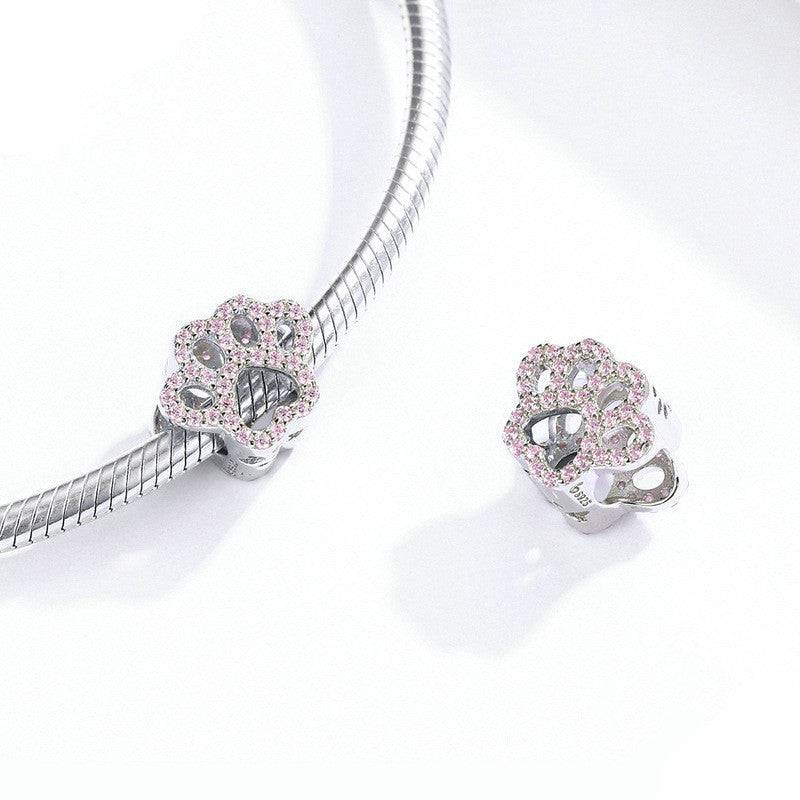 Cute Pink Paw Charm for Bracelets displayed with a silver bracelet, perfect gift for pet lovers and jewelry enthusiasts.
