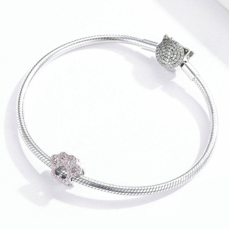 Sterling silver bracelet with Cute Pink Paw Charm attached, ideal accessory for animal lovers and charm bracelet fans.
