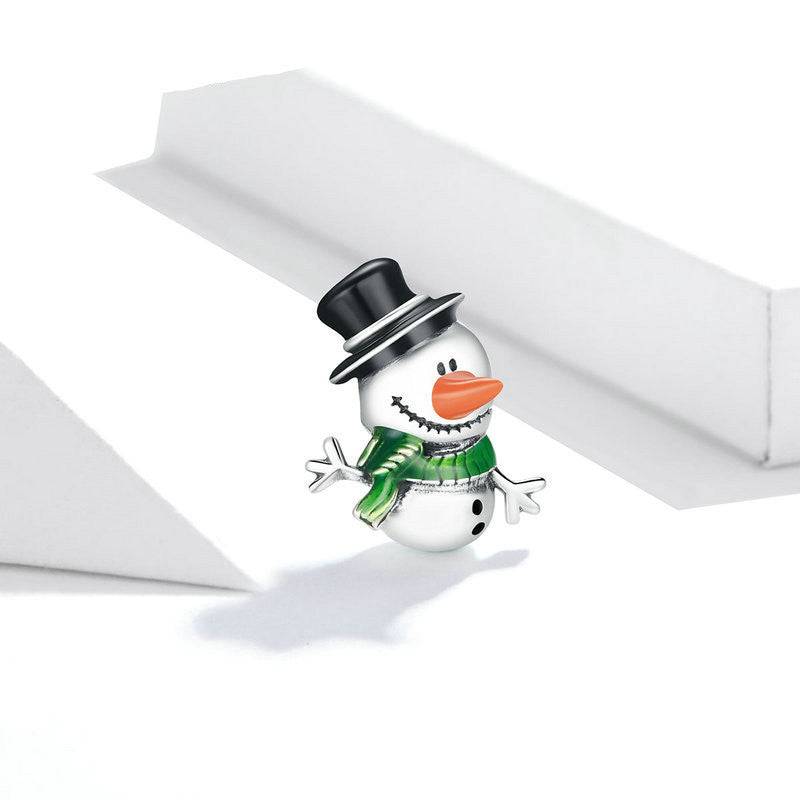Close-up of snowman charm with detailed black hat and green scarf.