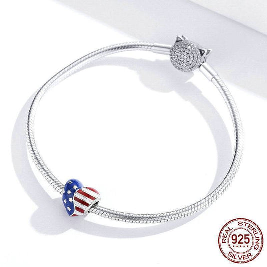 Sterling silver bracelet featuring a heart-shaped American flag charm, ideal for showcasing national pride in stylish accessories.