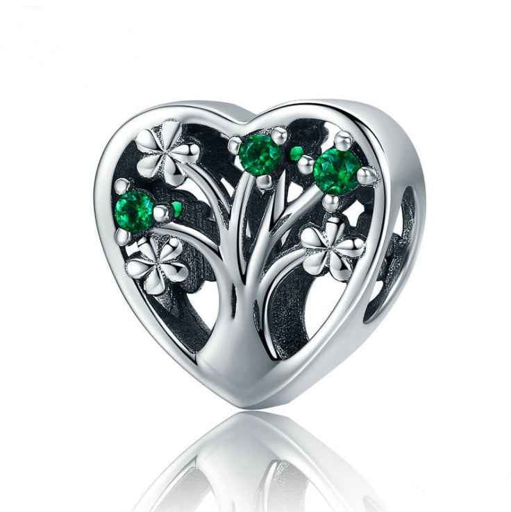 Heart Tree of Life Charm in sterling silver with green gemstones and floral accents, symbolizing strength and growth for charm bracelets.