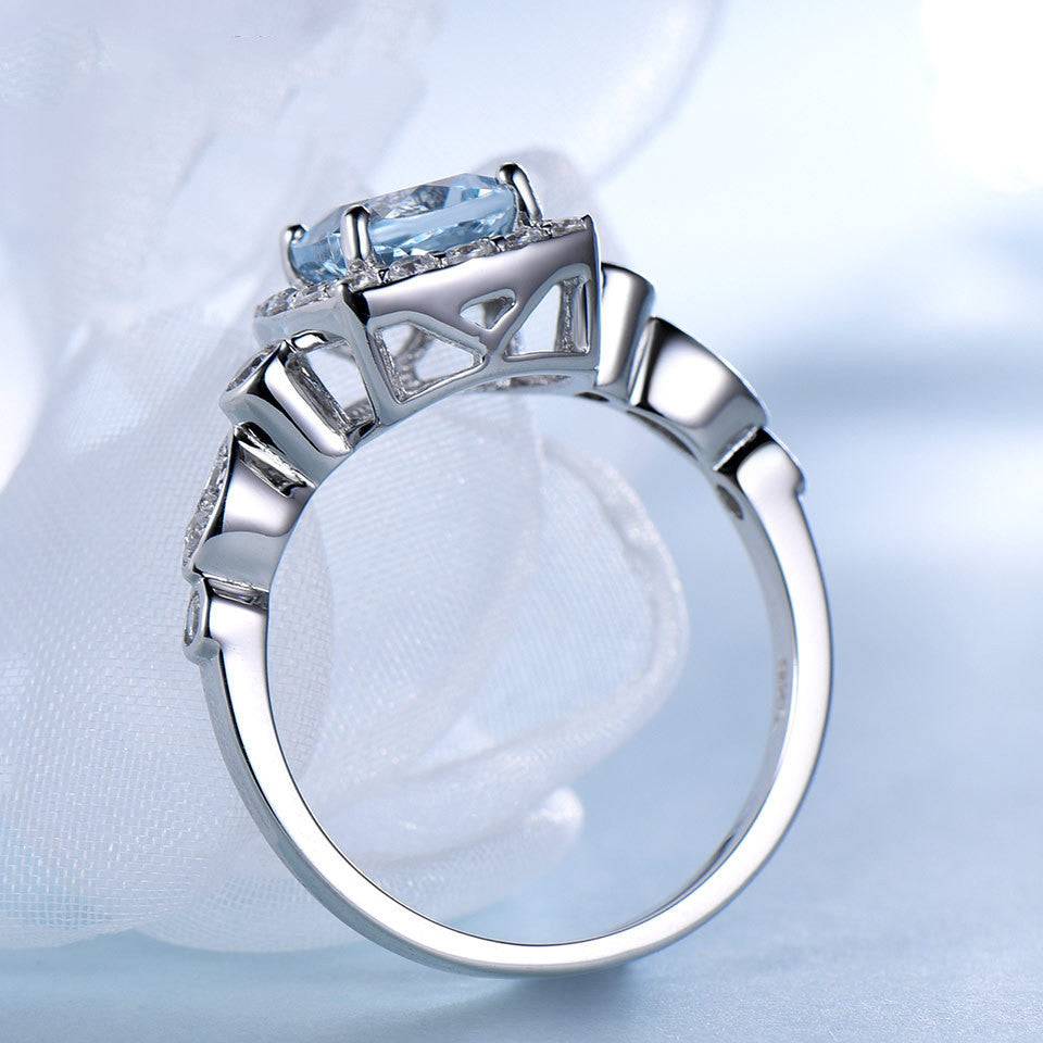 Side view of Sterling Silver Blue Topaz Ring showcasing intricate band design and elevated gemstone setting in 925 silver.