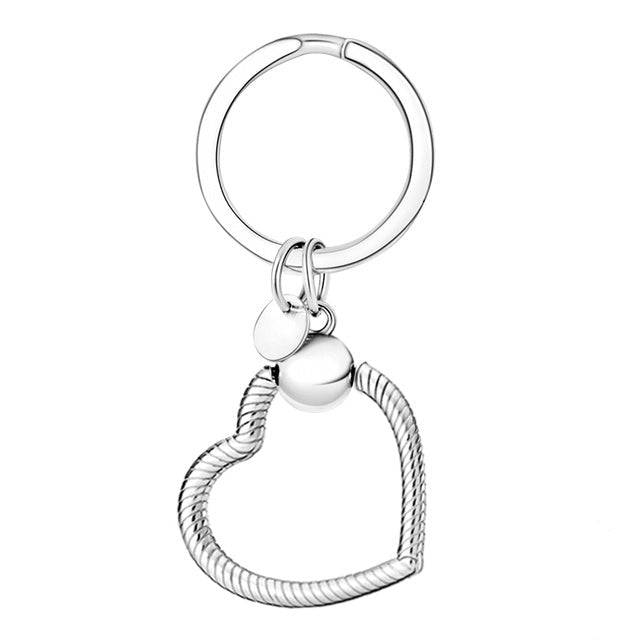 Silver heart-shaped keyring charm holder with a secure attachment. Durable and stylish design for showcasing charms with elegance.