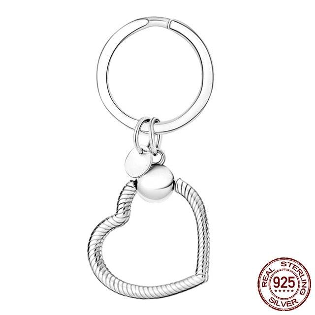 Heart-shaped silver keyring charm holder with a secure clasp. Elegant and durable design for showcasing charms with style.