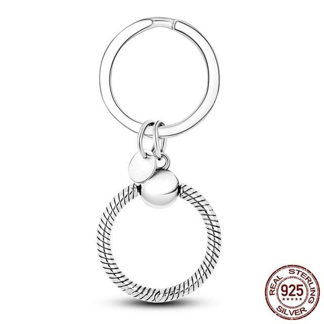 Round silver keyring charm holder with a secure clasp. Made from durable sterling silver for versatile and stylish charm attachment.