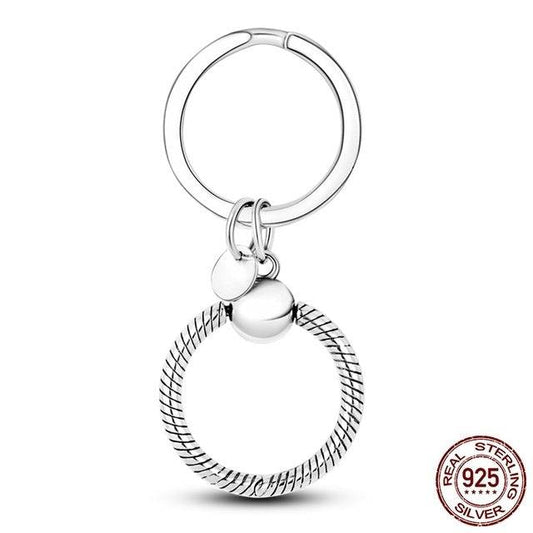 Round silver keyring charm holder with a secure clasp. Made from durable sterling silver for versatile and stylish charm attachment.
