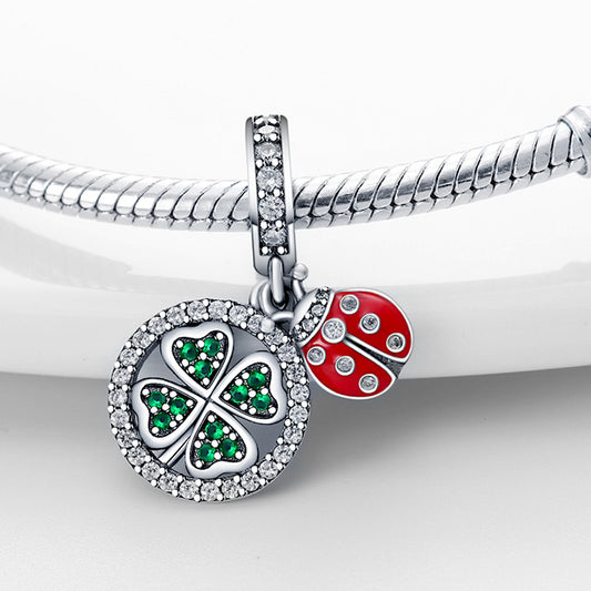 Lucky Charm featuring a sparkling clover and ladybird pendant attached to a silver bracelet, ideal for daily wear to attract luck.