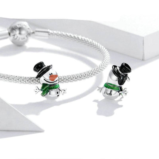 Snowman charm displayed on a silver bracelet, showcasing festive design.