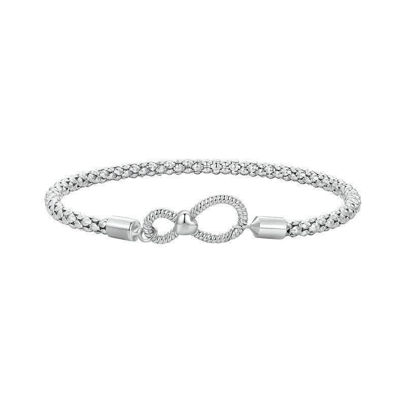Infinity Knot Silver Bracelet featuring a textured sterling silver band and elegant infinity symbol clasp. Ideal for timeless jewelry collections.