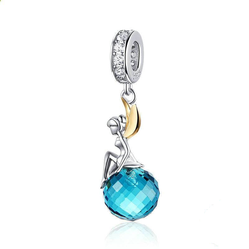 Blue Crystal Fairy Charm with a faceted blue gemstone and sterling silver fairy with gold-tone wings. Perfect for bracelets and necklaces.