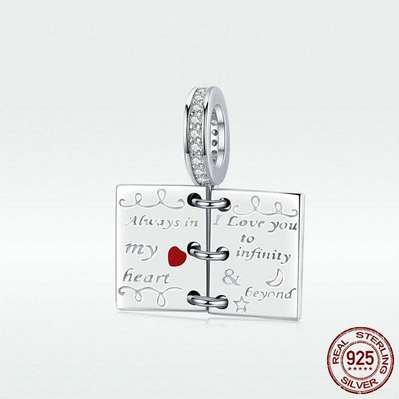 Detailed view of Romantic Love Notes Charm for Bracelets in sterling silver, featuring 'I love you to infinity & beyond' engraving and red heart.