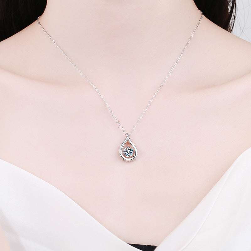 Droplet Moissanite Necklace worn by model, highlighting its delicate silver chain and teardrop pendant with 1-carat moissanite centerpiece.