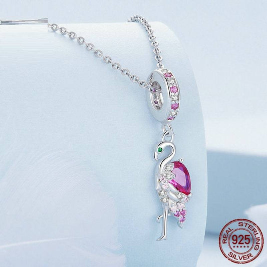 Tropical-inspired cute flamingo charm hanging on a silver necklace, crafted in 925 sterling silver with pink gemstone accents.
