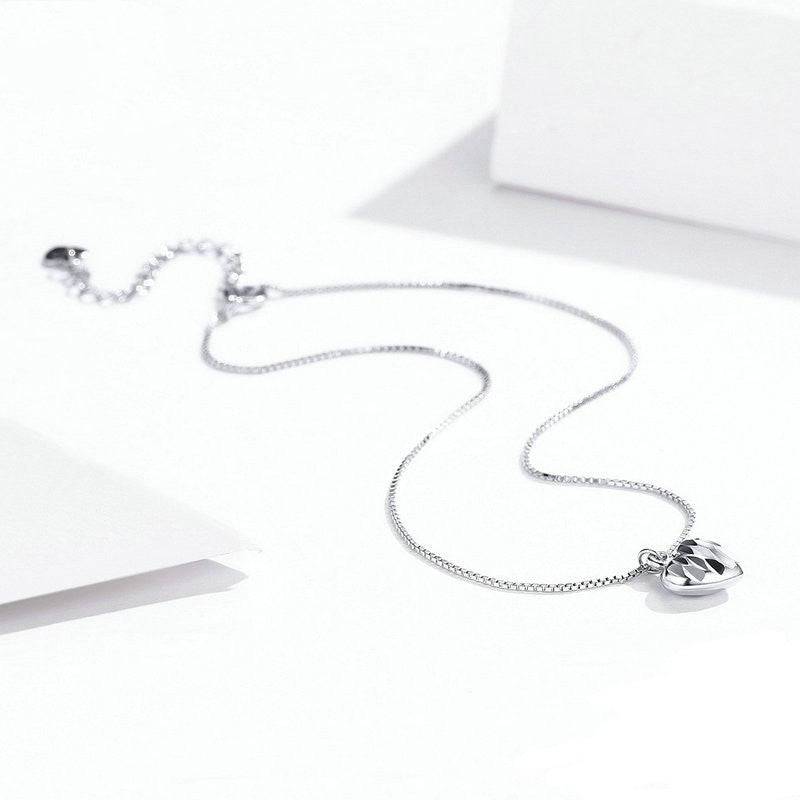 Charming Dangle Heart Anklet laid flat with shimmering heart charm. Perfect accessory for love-themed outfits and gifts.