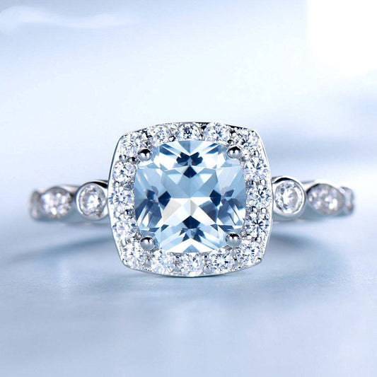 Elegant Sterling Silver Blue Topaz Ring featuring a nano sky blue topaz and sparkling halo, ideal for fine jewelry collections.