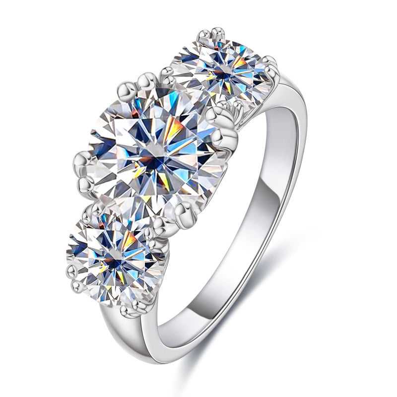 Trio Moissanite Ring featuring three dazzling 5 Karat D Color moissanite stones set in sterling silver. Luxurious and affordable fine jewelry.