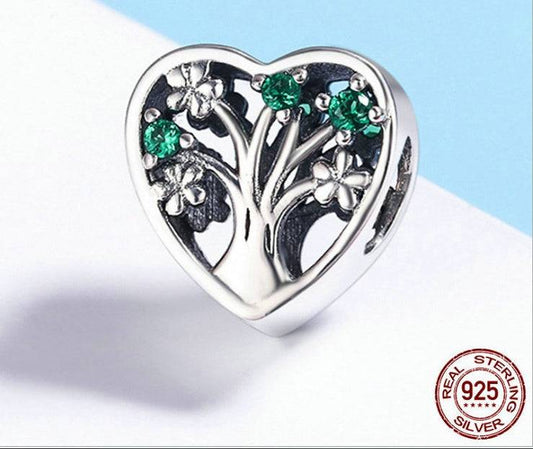 Sterling silver Heart Tree of Life Charm featuring green crystals and flower details, representing resilience and elegance in jewelry design.