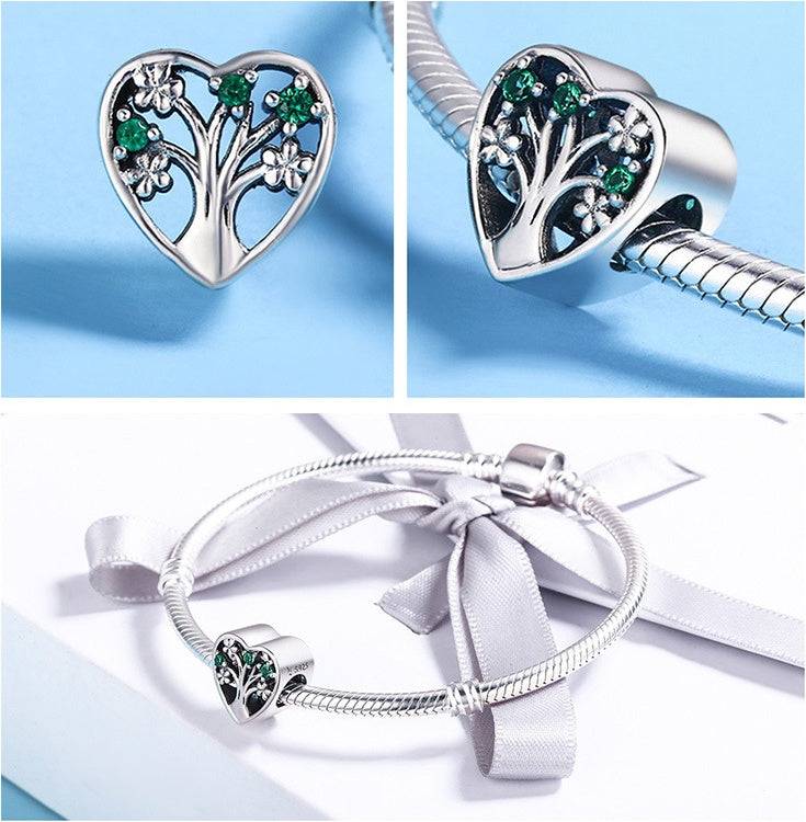 Heart Tree of Life Charm shown on a silver bracelet, highlighting its symbolic design of strength and growth with green gemstone accents.