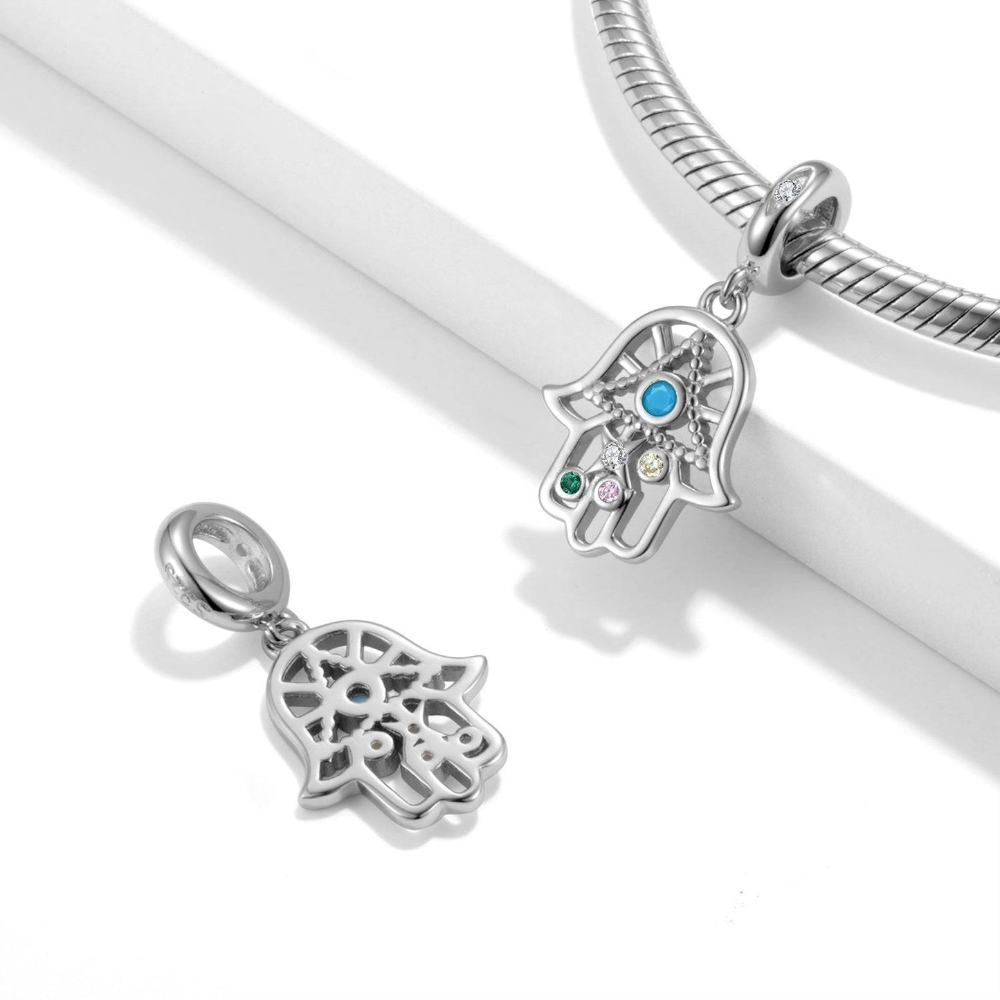 Protective Hamsa Hand Charm for Bracelets featuring colorful gemstones and intricate silver detailing, symbolizing luck and spiritual protection.