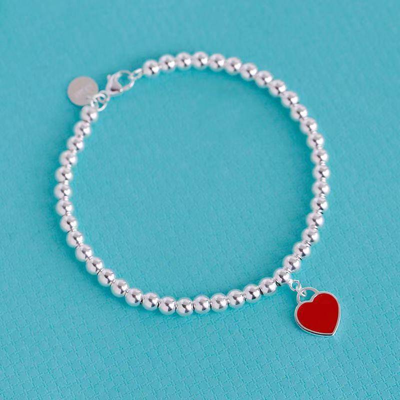 Timeless silver bracelet featuring red heart tag charm, perfect personalised gift for adding elegance to any outfit.