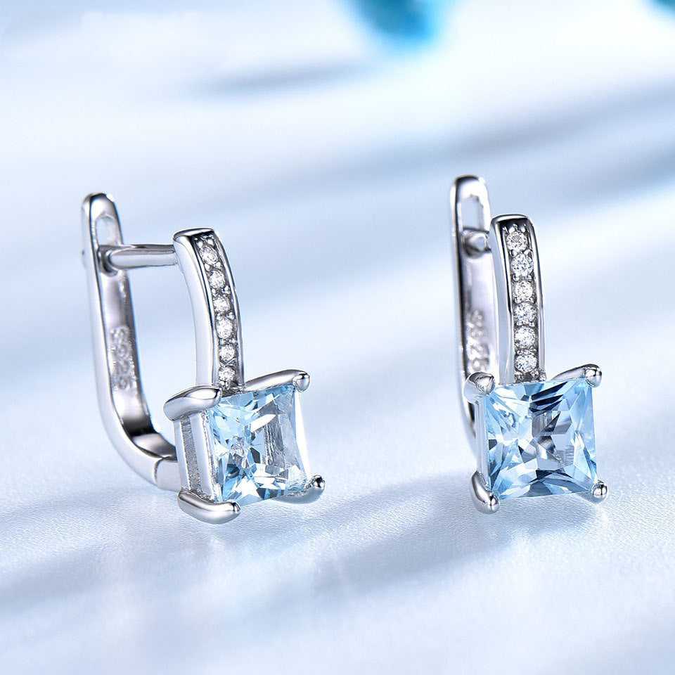Close-up of Sky Blue Topaz Earrings - Silver Craftsmanship highlighting the clarity of the topaz and sparkle of the cubic zirconia accents.