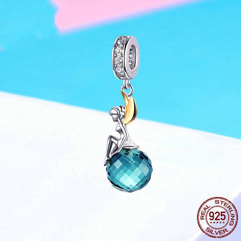 Elegant Blue Crystal Fairy Charm with a faceted blue gemstone and sterling silver fairy, ideal for adding a magical touch to jewelry collections.