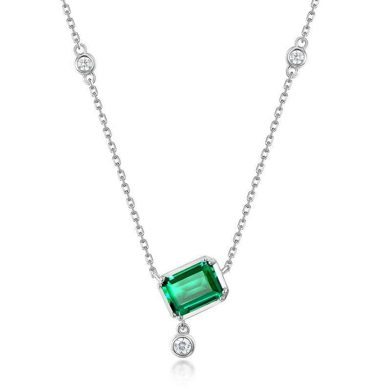 Emerald Necklace - Rectangular Design with 6x8mm green emerald pendant and silver cross chain featuring bezel-set diamonds.