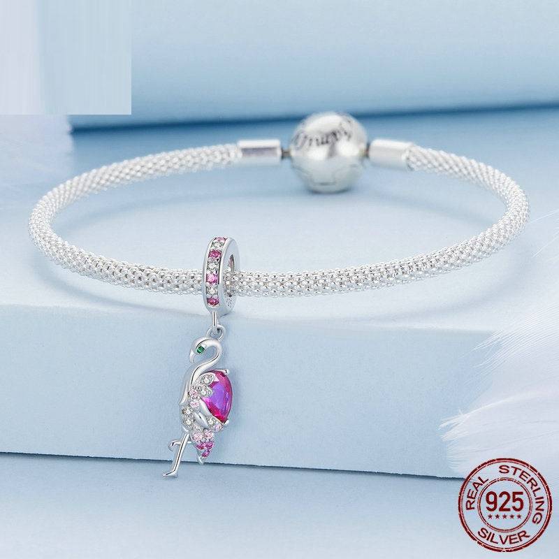 Sterling silver bracelet with adorable cute flamingo charm, showcasing a vibrant pink gemstone and tropical design.