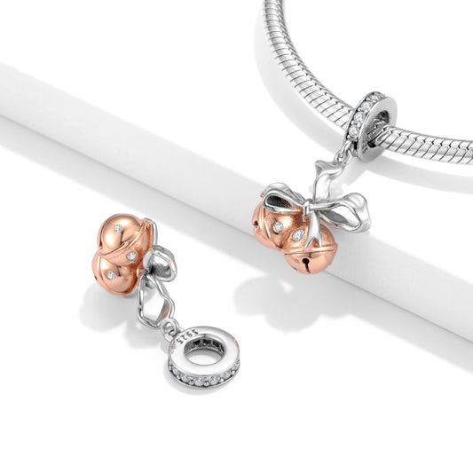 Bells Charm shown on a bracelet and separately, highlighting its festive ribbon design and rose gold bells for elegant accessorizing.