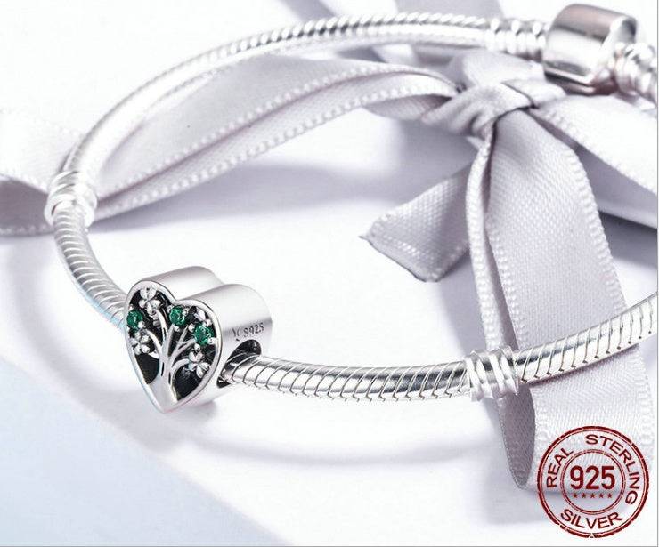 Close-up of Heart Tree of Life Charm on a sterling silver bracelet, perfect for meaningful jewelry collections and personal style.