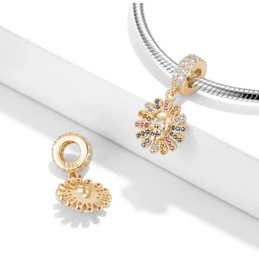 Gold Sunflower Skull Charm with rainbow crystals shown on a bracelet and separately, ideal for bold, stylish charm collections.