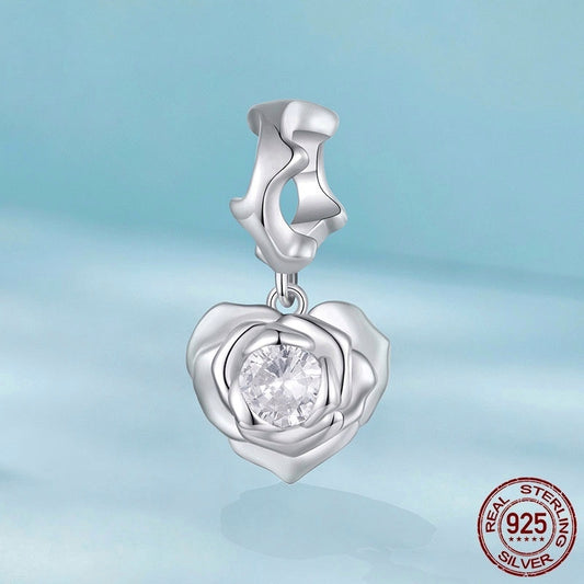Sterling silver Rose Heart Charm featuring a brilliant crystal center, ideal for romantic jewelry gifts. Certified 925 silver for lasting quality.