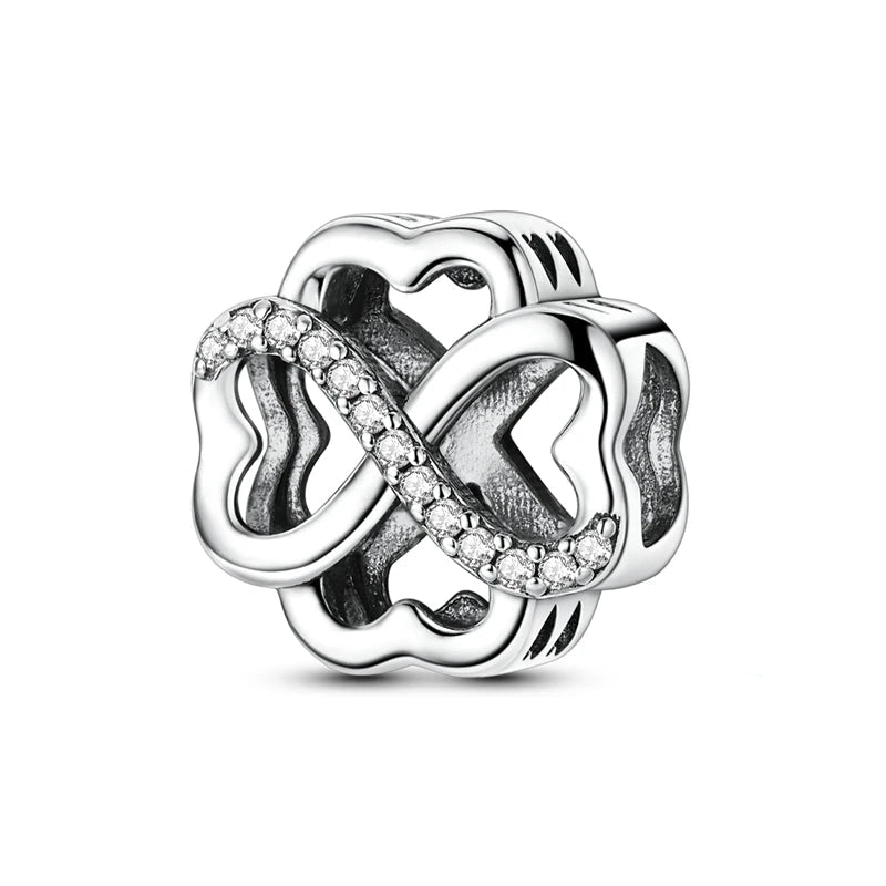 Silver charm with interlocking hearts and clear stones on a white background, featuring 'Real Sterling Silver 925' stamp.