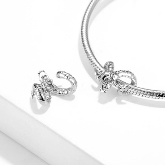 Close-up of Gothic Goat Head Charm on a silver bracelet, showcasing its intricate design and compatibility with charm bracelets.