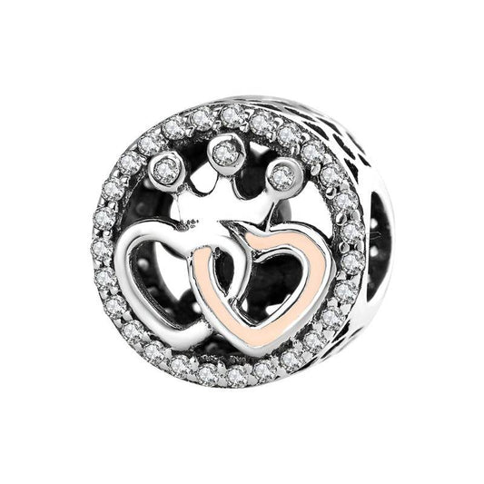 Silver charm with dual interlocking hearts and crown design, accented with crystals. Ideal romantic gift for charm bracelets.