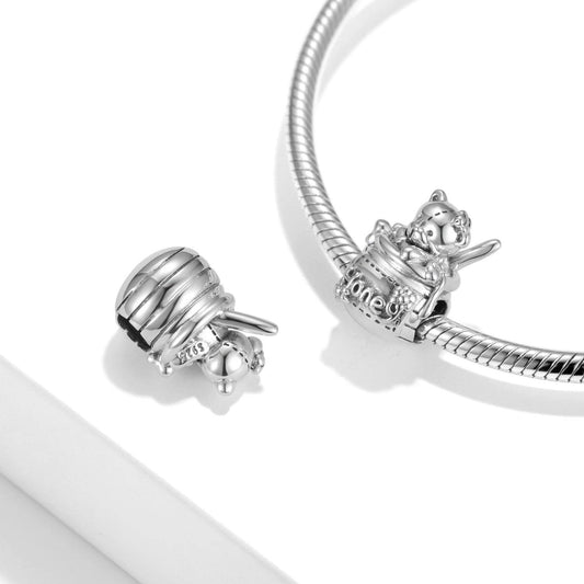 Honey Jar Charm displayed on a silver bracelet, showcasing its intricate teddy bear and honey pot design. A perfect gift for charm collectors.