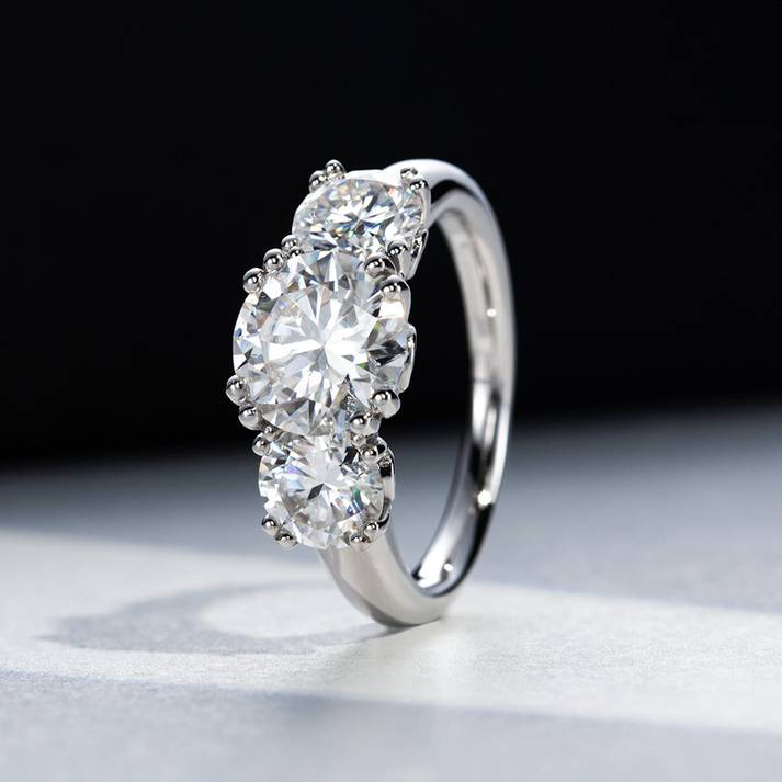 Trio Moissanite Ring with 5 Karat moissanite stones reflecting light beautifully. Premium sterling silver band for a sophisticated look.
