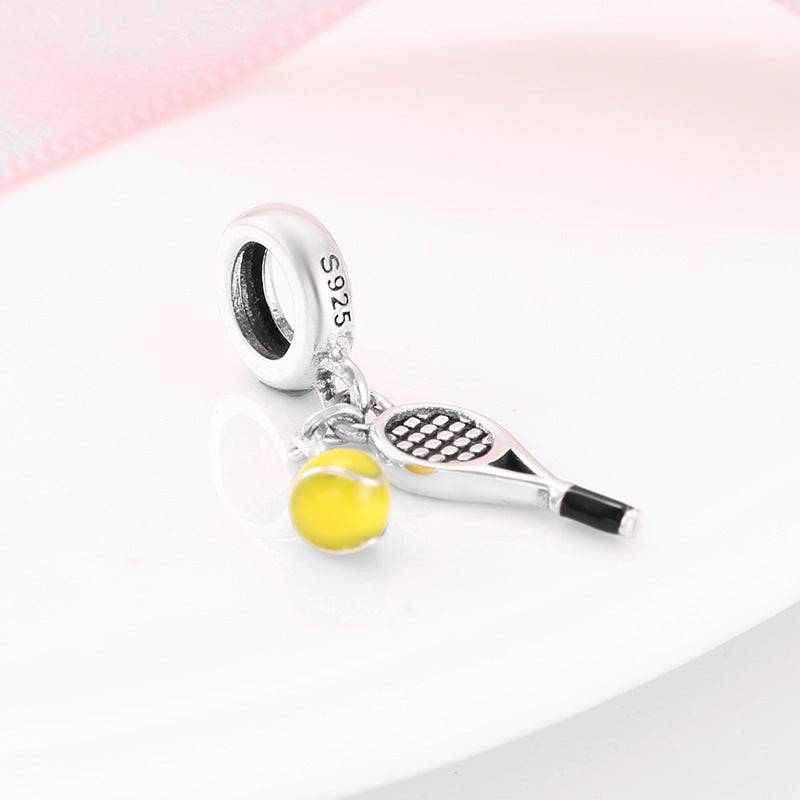 Close-up of Sports Charm with tennis racket and yellow ball, crafted in 925 sterling silver for athletic-themed accessories.