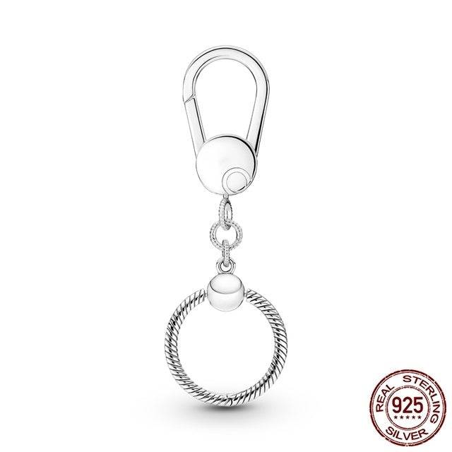 Silver keyring charm holder with a secure clip attachment. Crafted from real sterling silver for durability and versatile charm display.