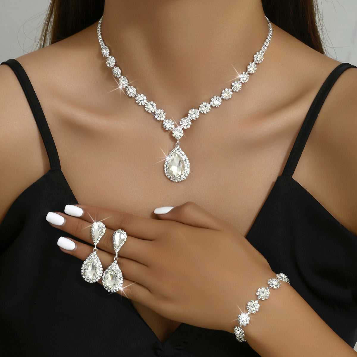 White crystal Three-piece Jewellery Set - Complete Set | Elegant Trio with shimmering teardrop necklace, earrings, and bracelet for weddings or events.