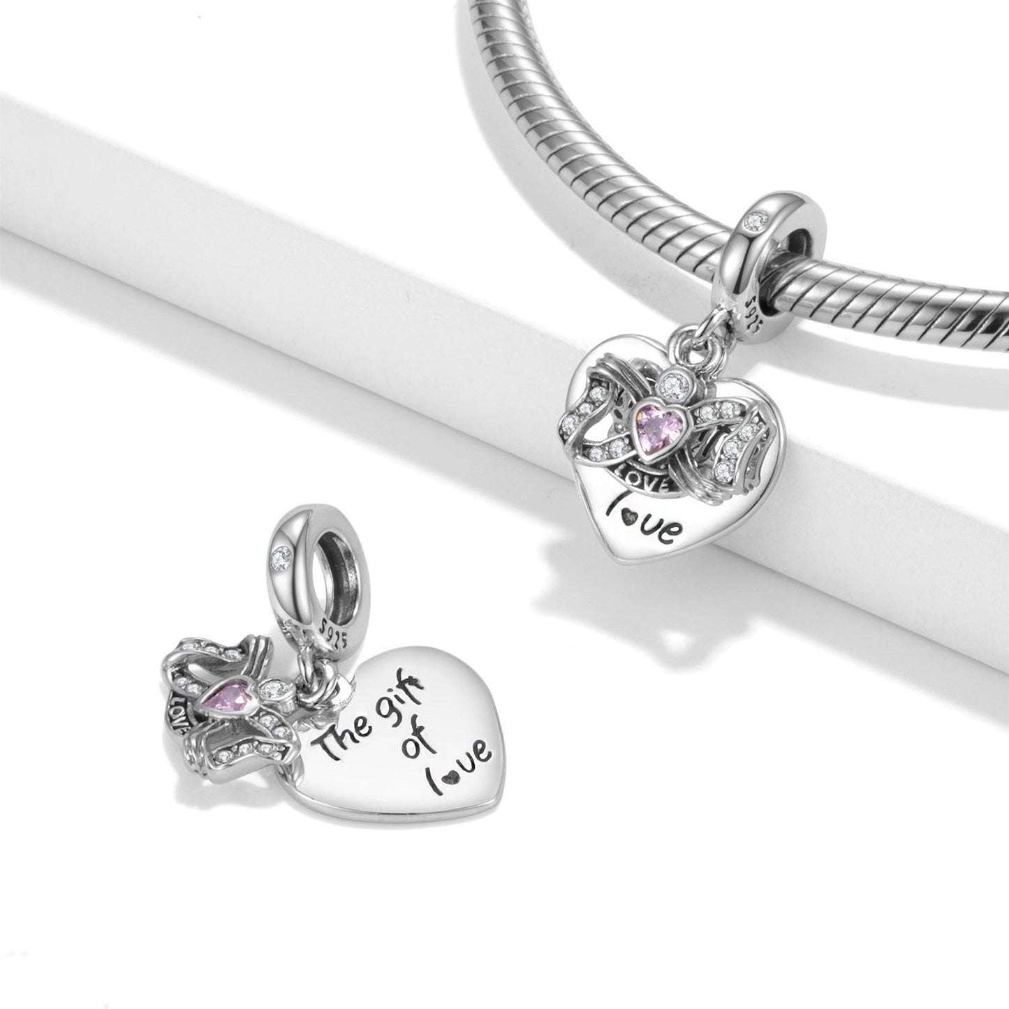 Gift of Love Charm for Bracelets features a heart-shaped sterling silver design with pink gemstone and engraved romantic message.