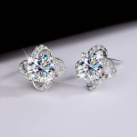 Spiral Moissanite Earrings with dazzling center stones and silver loops encrusted with smaller gems. Perfect for elegant and radiant style statements.